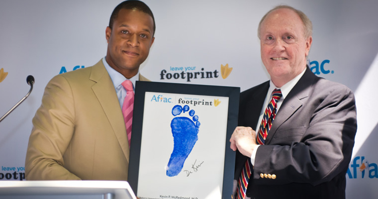 people posing with / receiving a Footprints award for contributions