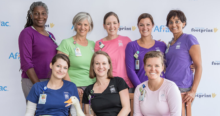 people pose with Aflac duck