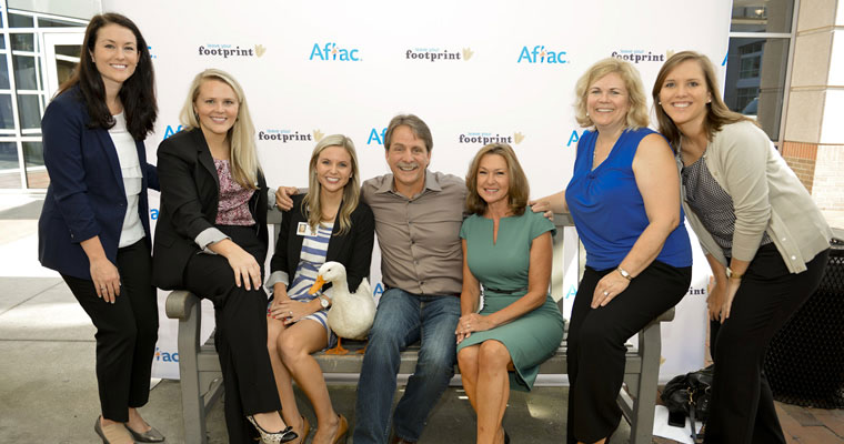 people pose with Aflac duck