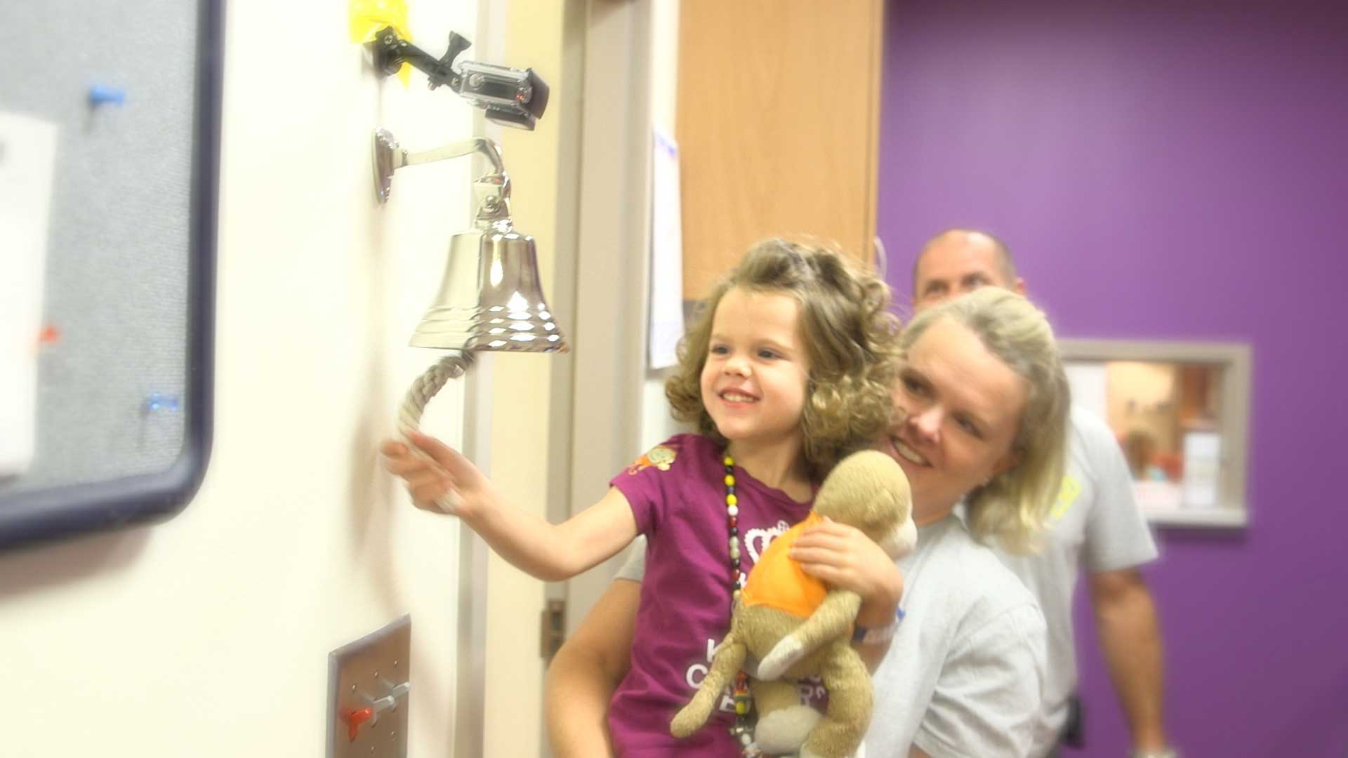 little girl ringing the 'end of treatment bell'