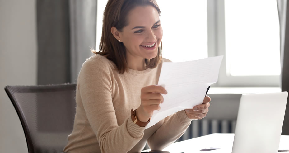 woman reading insurance claim documents