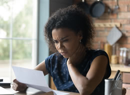 woman looking at a medical bill