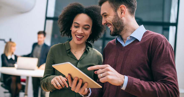 man and woman looking at tablet