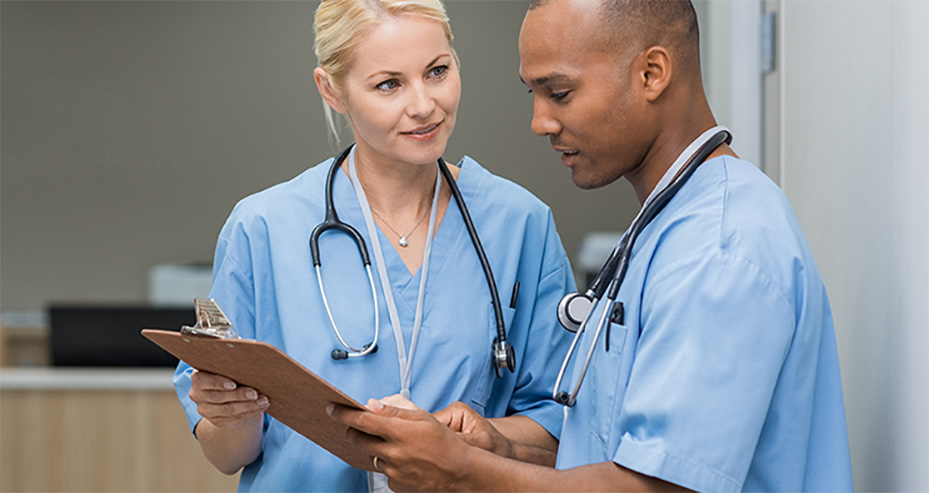 Doctor and nurse discussing treatment plans.