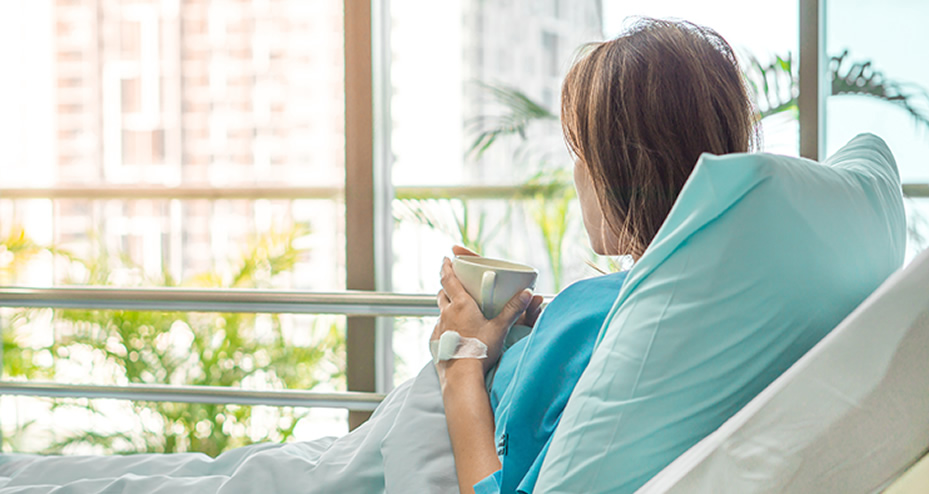 woman laying in bed drinking coffee