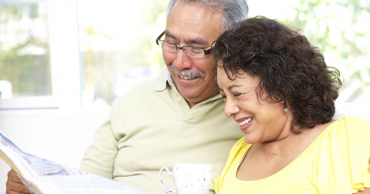 older couple reading newspaper together
