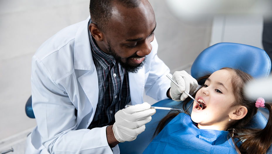 dentist examining a young girl