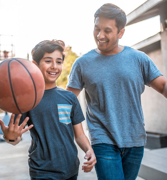 father and son playing basketball