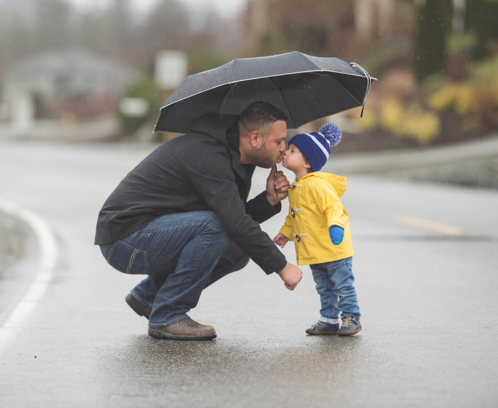 father and son under umbrella