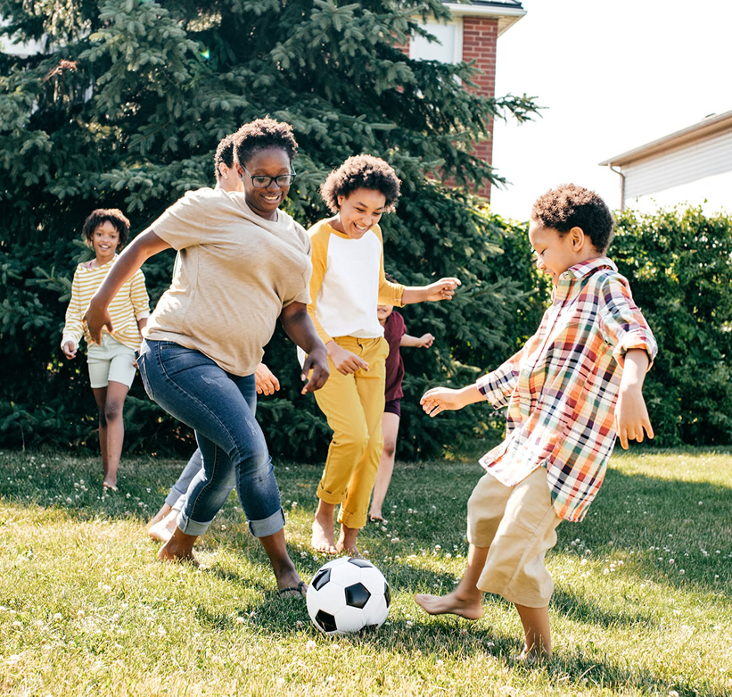 kids playing soccer in a yard
