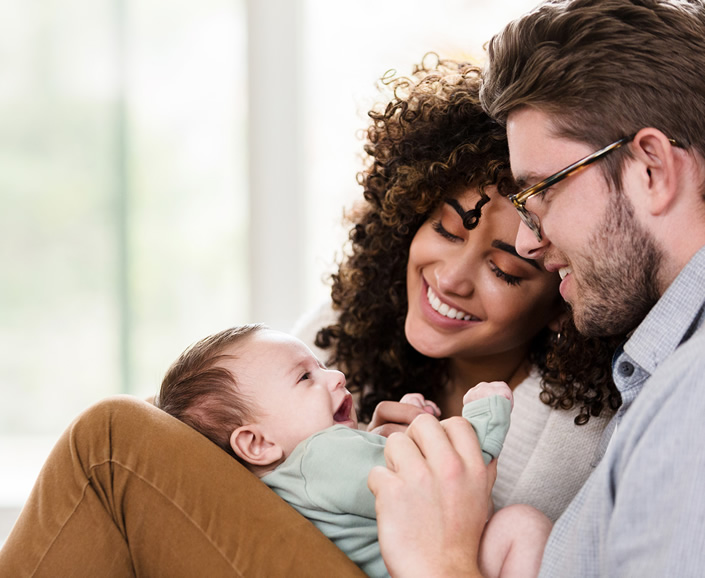 mother and father holding their baby