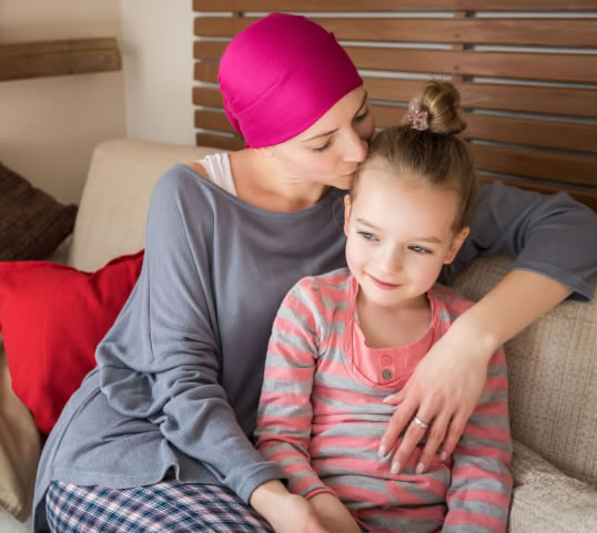 Mother with cancer hugging daughter