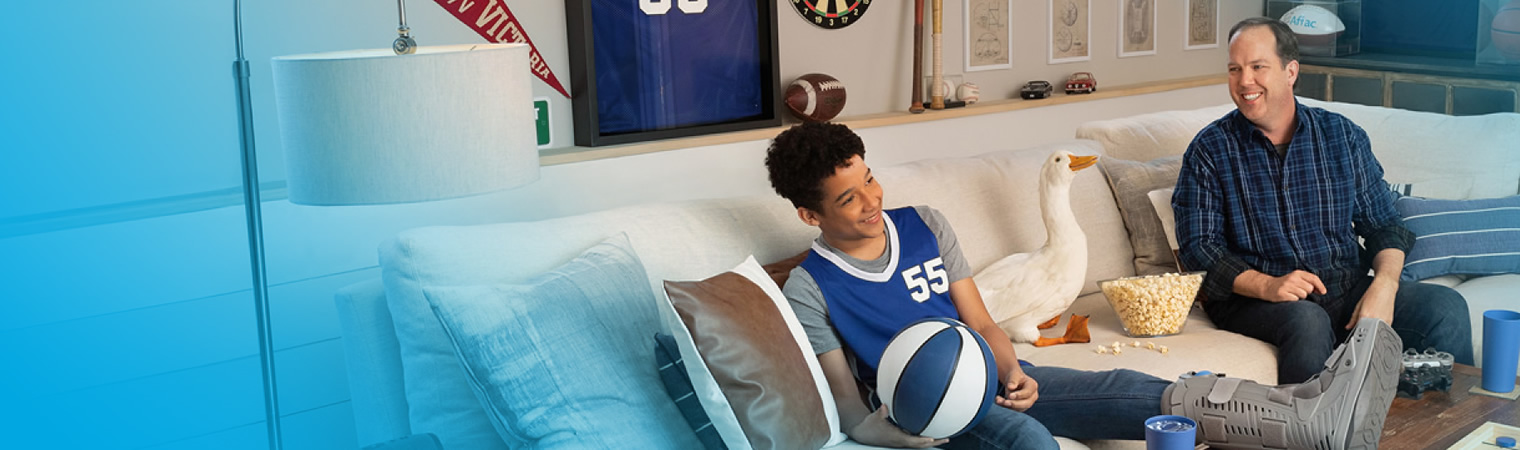 A young basketball player recovering at home with an adult and the Aflac duck