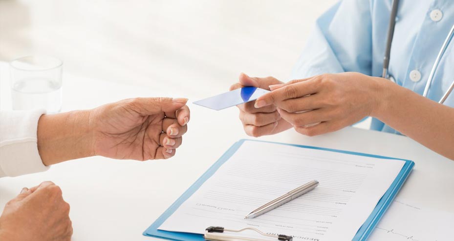 health care provider handing card to patient