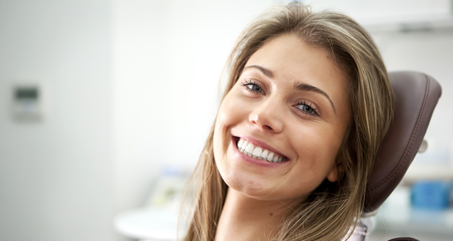 dental patient sitting in chair smiling