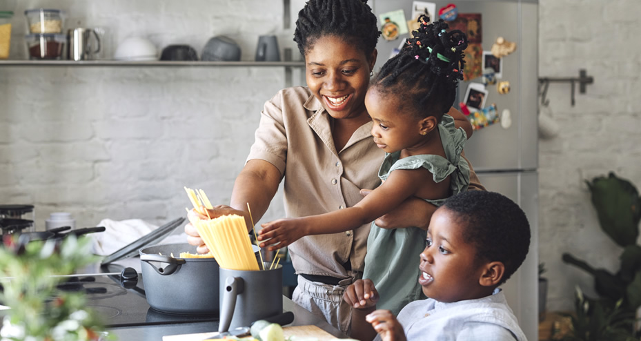 family making spaghetti in the kitchen