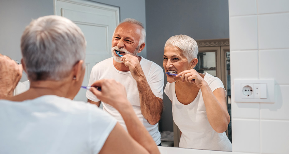 older couple brushing their teeth