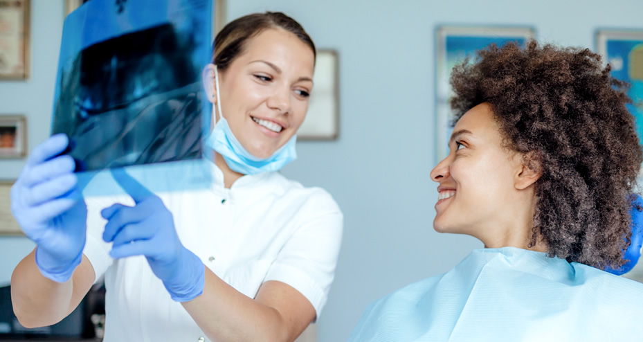 dentist reviewing x-rays with patient