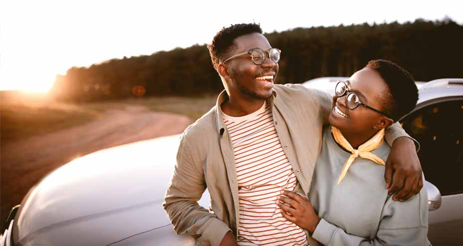 couple hugging outside of a car