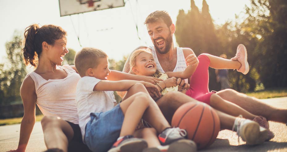 family playing basketball together