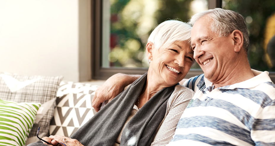 older couple sitting on a couch