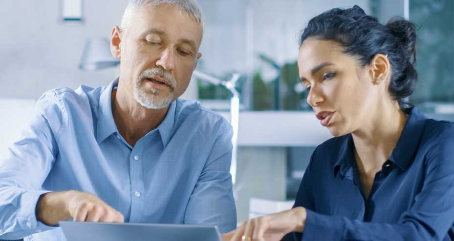 coworkers pointing at laptop