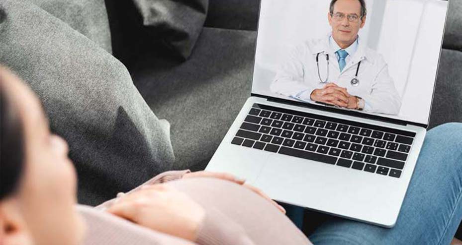 pregnant woman talking with doctor on laptop