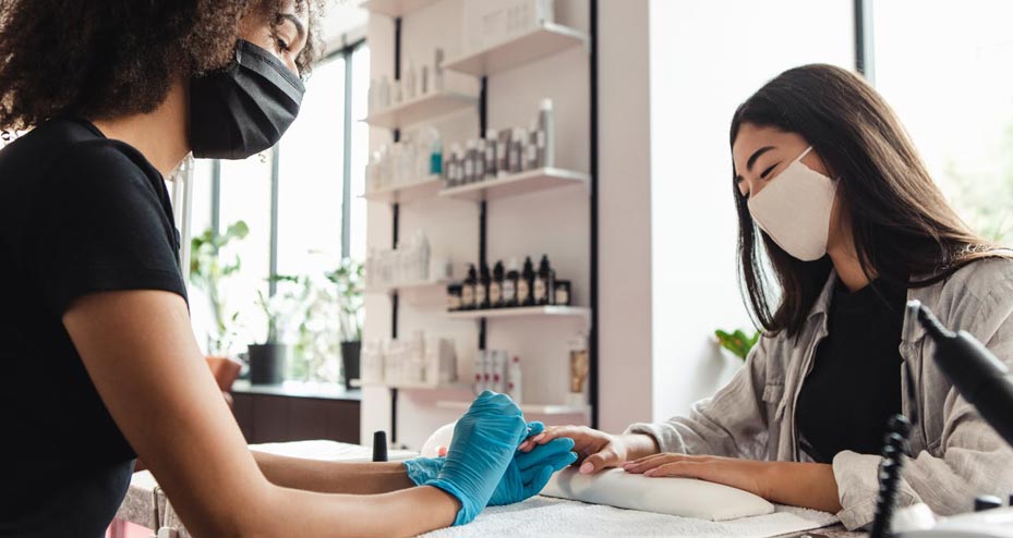 women getting nails done at salon