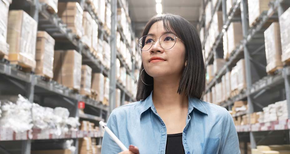 woman looking up in warehouse