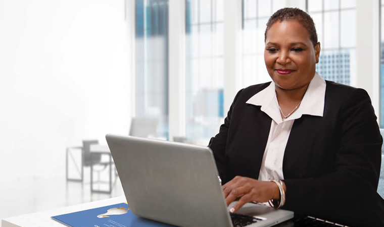 Aflac agent at desk using computer