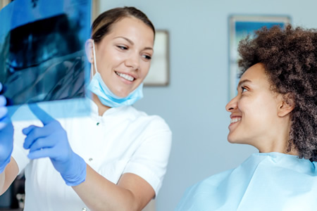 dentist discussing x-ray results with patient