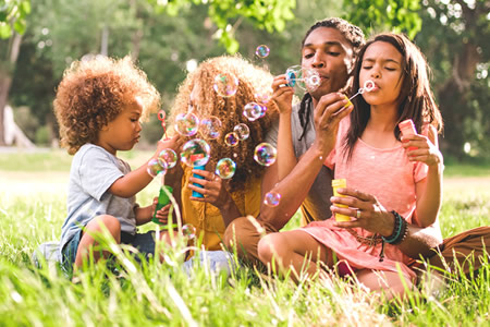 Family blowing bubbles