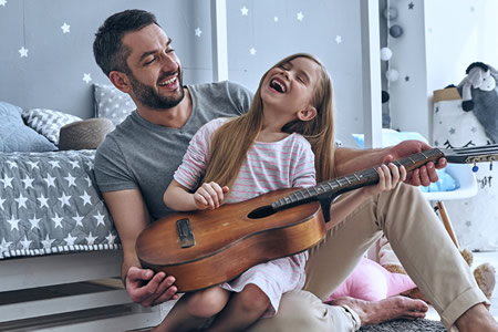 Father and daughter with guitar